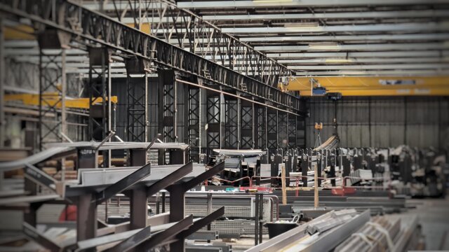 Modern metalworking facility generating wastewater with heavy metals, acids and surfactants requiring precise treatment for STM‑BREF compliance.